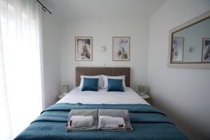 a bedroom with a bed with two towels on it at Blue Horizon Apartment in Jadranovo