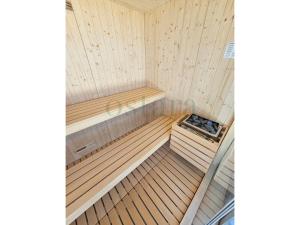 an inside of a sauna with a wooden tub at Glycine Jasmim in Castro Marim