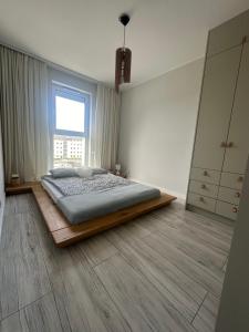 - une chambre avec un lit et une grande fenêtre dans l'établissement New Town, à Zielona Góra