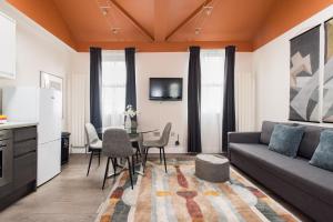 a living room with a couch and a table at Charming Euston in London