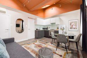 a living room with a couch and a table at Charming Euston in London