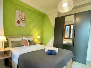 a bedroom with a large bed with green walls at Apartment w/ New Furnitures Next to Istiklal Street and Taksim Square in Istanbul