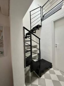 a black staircase in a room with a tiled floor at Casuzza - la comodità che cerchi in Noto