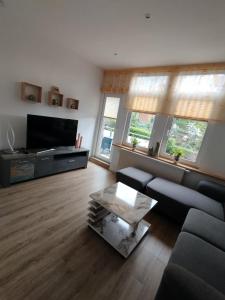 a living room with a couch and a flat screen tv at Ferienwohnung Lehmann - Wernigerode in Wernigerode