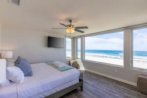 a bedroom with a bed and a view of the beach at B5026 Rockaway Oceanfront 2 in San Diego