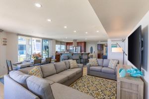 a living room with two couches and a kitchen at B5026 Rockaway Oceanfront 2 in San Diego