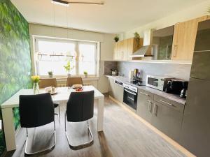 a kitchen with a table and chairs in a kitchen at Fewo Stever-Aue in Lüdinghausen
