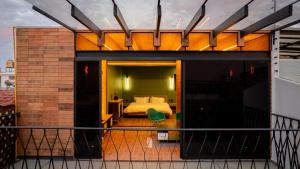 a bedroom with a bed on a balcony at Casa Ann Loft Eames in Morelia