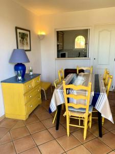 a dining room with a yellow table and chairs at Les Maisons de Pont Royal en Provence - maeva Home - Maison 3 pièces 6 personnes - Sélection MAE-2277 in Mallemort