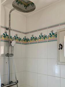 a white tiled bathroom with a shower with at Les Maisons de Pont Royal en Provence - maeva Home - Maison 3 pièces 6 personnes - Sélection MAE-2277 in Mallemort