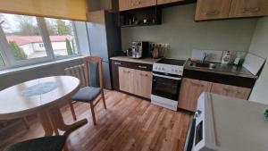 a small kitchen with a table and a table and chairs at Apartamenti dzīvoklis Ogre. in Ogre +13 photos