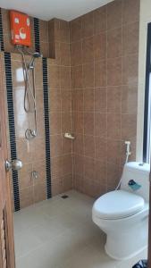 a bathroom with a shower and a toilet in it at The chev hotel in Ban Nong Pla Duk