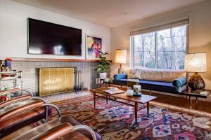 a living room with a couch and a fireplace at Peace on the Potomac RiverViews NationalHarbor in Fort Washington