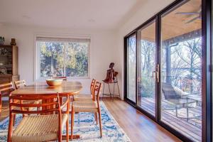 a dining room with a wooden table and chairs at Peace on the Potomac RiverViews NationalHarbor in Fort Washington