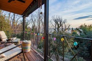 a screened in porch with a view of the woods at Peace on the Potomac RiverViews NationalHarbor in Fort Washington