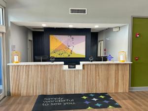 an office lobby with a reception desk with a presentation at Spark by Hilton Commerce, GA in Commerce +74 photos