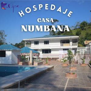 a resort with a swimming pool in front of a building at Casa Numbana in Norcasia