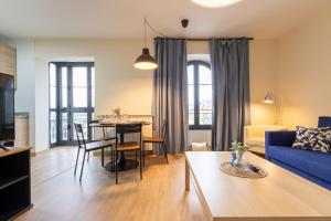 a living room with a blue couch and a table at InsideHome Ciudad de Avilés in Avilés +24 photos