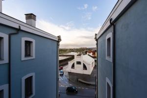 a view of a building from between two buildings at INSIDEHOME Ciudad de Avilés in Avilés