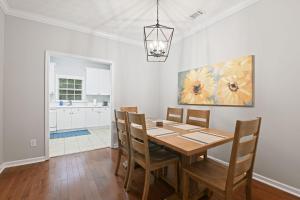 a dining room with a wooden table and chairs at Tiger's Den On Dean in Auburn