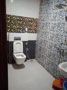 a bathroom with a toilet and a sink at Ishita villa in Lucknow