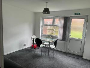 a dining room with a glass table and chairs at Homestay-Close to Coventry City and University I Free Parking I Wi-Fi in Coventry