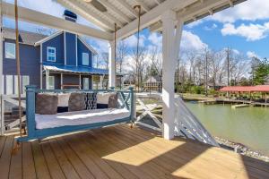 a porch swing on a house with a view of the water at Changes In Latitude in Dadeville