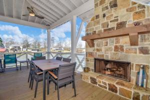 a patio with a fireplace and a table and chairs at Changes In Latitude in Dadeville