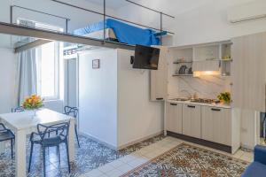a small kitchen and dining room with a loft bed at Le Suite del Castello in Castellammare di Stabia +77 photos