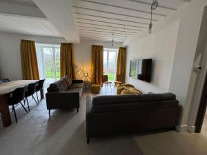 a living room with a couch and a table at Glebe House in Sion Mills