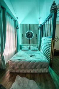 a bedroom with a large bed with blue lighting at Appartement d'une chambre avec piscine privee sauna et wifi a Montbeliard in Montbéliard