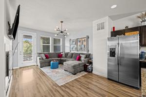 a living room with a couch and a refrigerator at Uptown Avenue - Broomfield in Broomfield