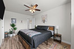 a bedroom with a bed and a ceiling fan at Uptown Avenue - Broomfield in Broomfield