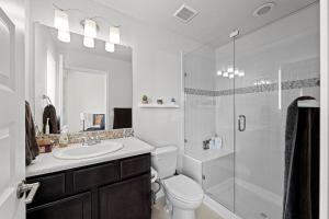a bathroom with a toilet and a sink and a shower at Uptown Avenue - Broomfield in Broomfield
