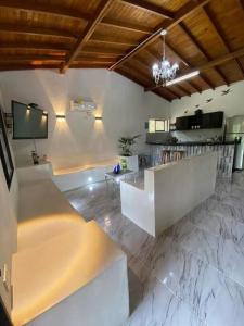 a large living room with a tub and a tv at Finca privada Monte sol para 15 personas in La Pintada