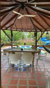 a patio with a table and chairs and a ceiling at Finca privada Monte sol para 15 personas in La Pintada