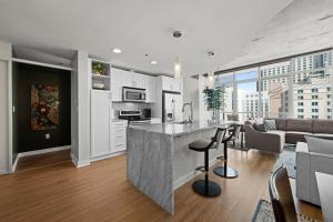 an open kitchen and living room with a couch at Spire - Unit 1810 in Denver
