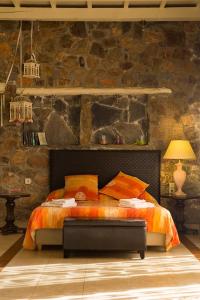 a bedroom with a bed and a stone wall at Seaview villa Amphitriti with Private Pool, 20 min from Elafonissi beach in Chania Town +17 photos