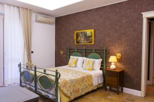 Ένα ή περισσότερα κρεβάτια σε δωμάτιο στο Villa Donna Grazia