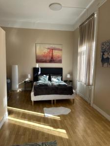 a bedroom with a bed and a large window at Rentalux Apartments at Nytorget in Sundsvall