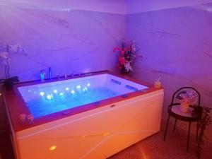 a large tub in a room with purple lighting at A Trecastagni - Etna Home in Trecastagni