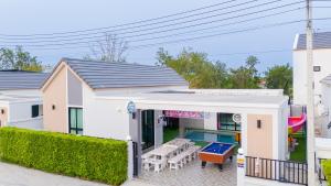 a house with a pool and a backyard at นาวาพูลวิลล่าหัวหิน VIP in Hua Hin