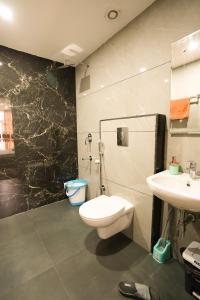 a bathroom with a toilet and a sink at Zaabeel Villa Kashmir in Srinagar