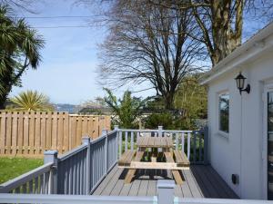 a picnic table on the porch of a house at 2 Bed in Brixham BX081 in Brixham