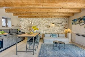 a kitchen and living room with a table and a couch at Villa Batalini in Šumber