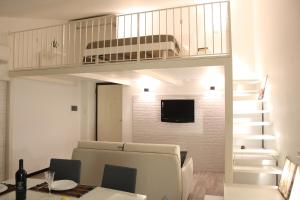 a living room with a loft bed and a dining room at Uno Spettacolo Della Natura, Modern Style in San Lucido