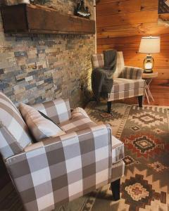 a living room with a couch and a chair at Clover Creek Cabin in Waynesville +18 photos