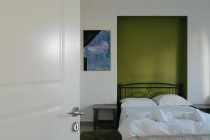 Posteľ alebo postele v izbe v ubytovaní Nefeli City Apartments