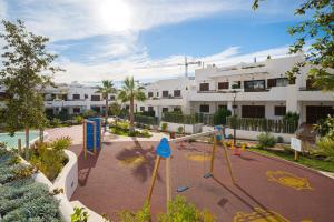 a playground in front of a apartment complex at Tortuga Marina in San Juan de los Terreros