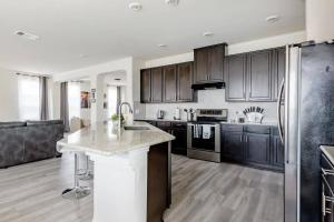 a kitchen with black cabinets and a white counter top at Luxury Master Room 1 In Austin's Mckinney Falls in Austin